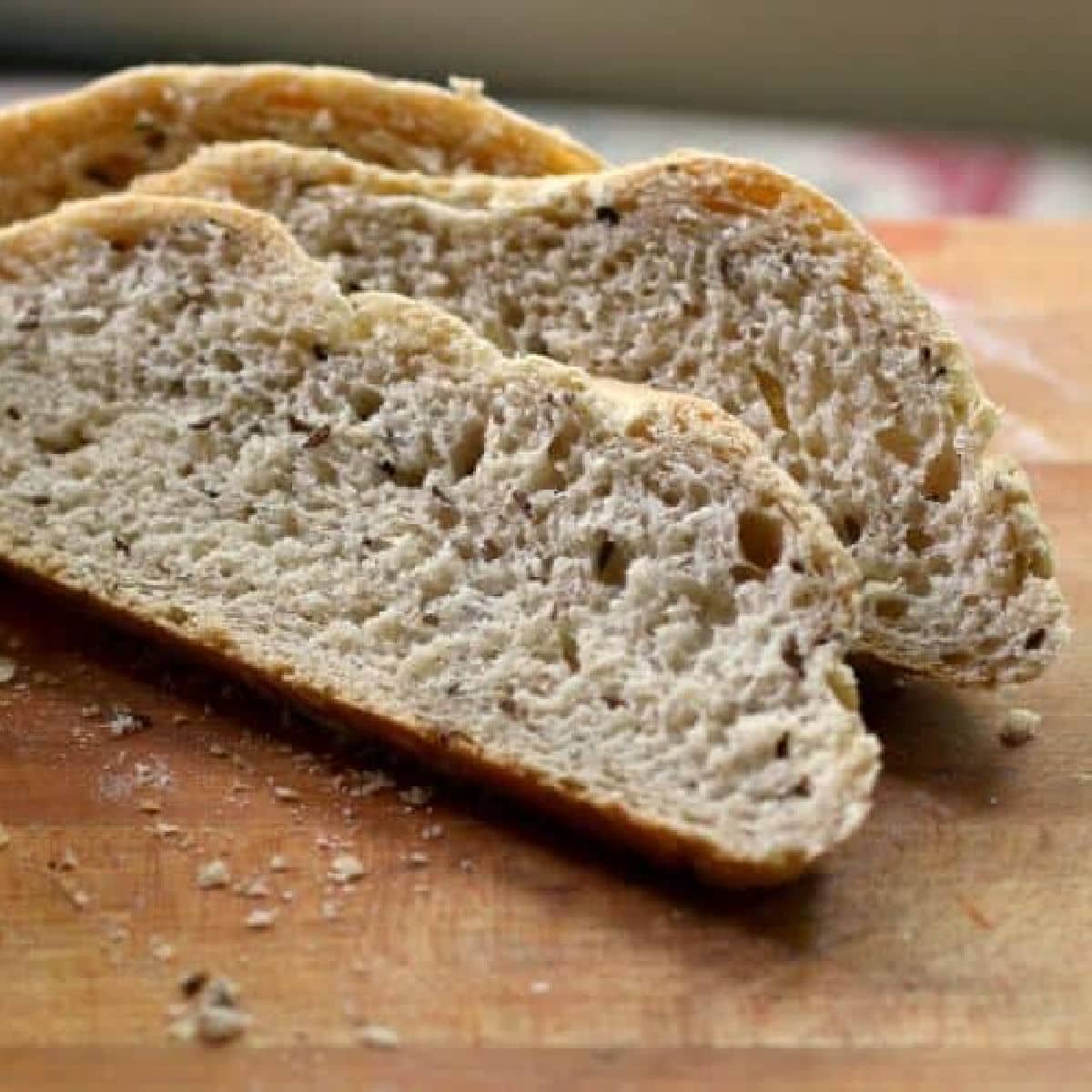 Slices of Jewish rye bread on a cutting board.