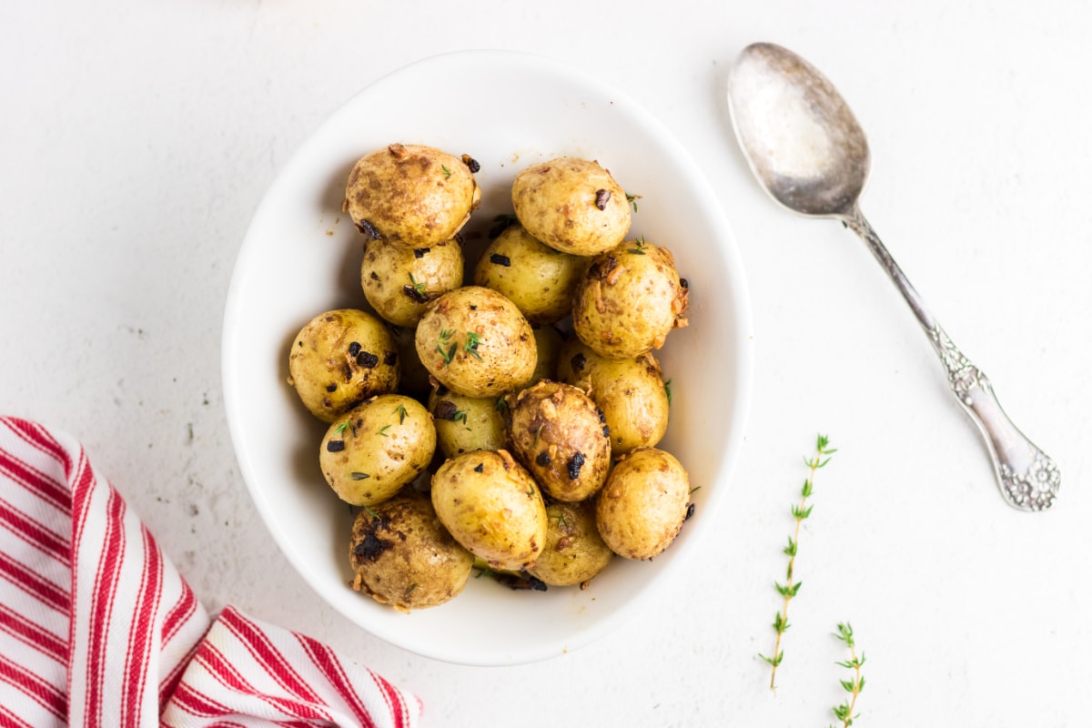 Overhead view of Lipton onion soup potatoes in a bowl on a white table.