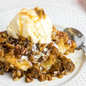 Closeup view of a serving of pecan pie cobbler on a plate.