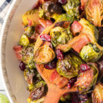 Overhead view of bowl of roasted brussels sprouts with a title text overlay for Pinterest.