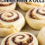 Cinnamon rolls on a baking pan ready to be put in the oven. TItle text overlay for Pinterest.