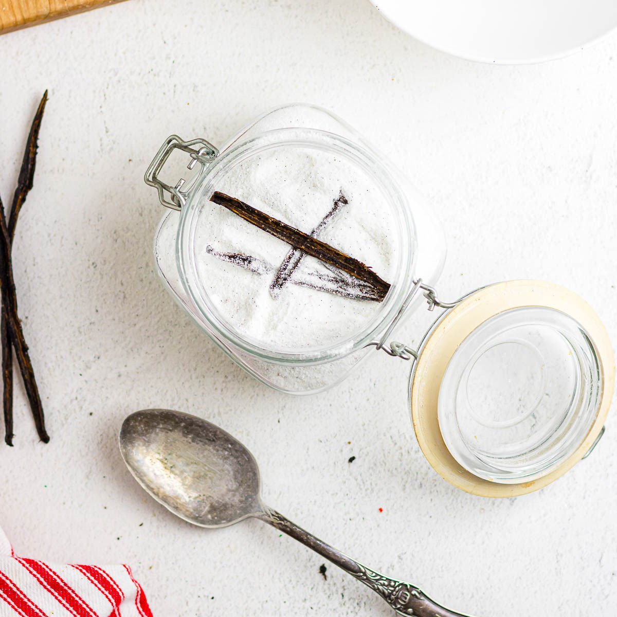 Overhead view of vanilla sugar in a storage container.