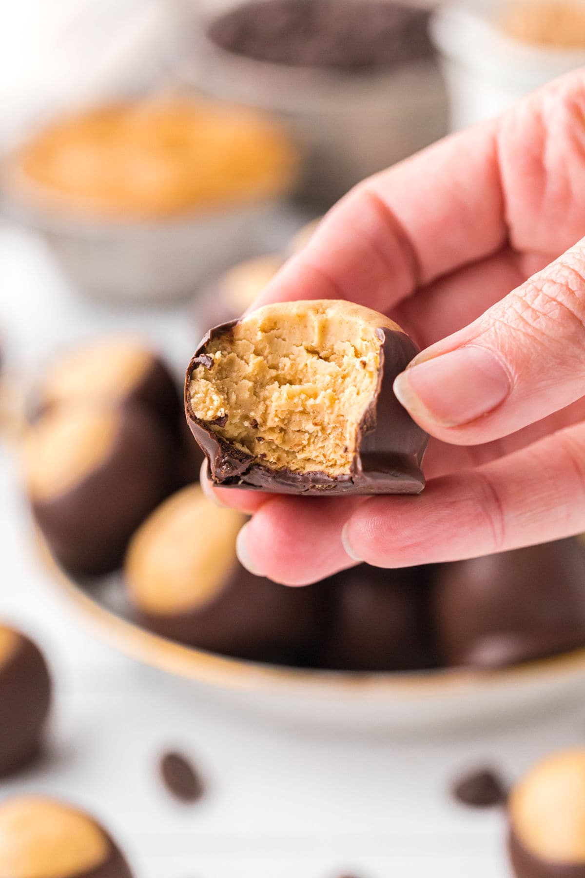 An up-close photo of a buckeye with a bite taken out of it.