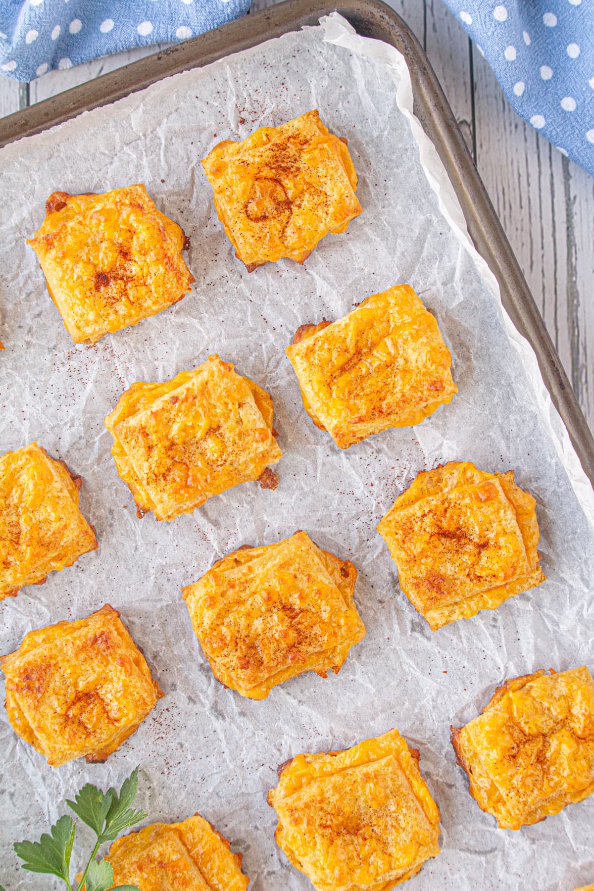 An overhead view of baked cheese dreams on a baking sheet.