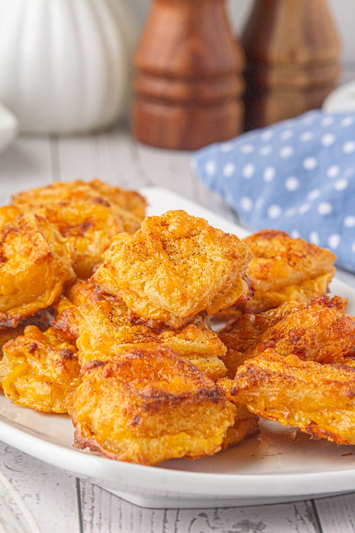 An up-close photo of crisp cheese dreams on a plate.