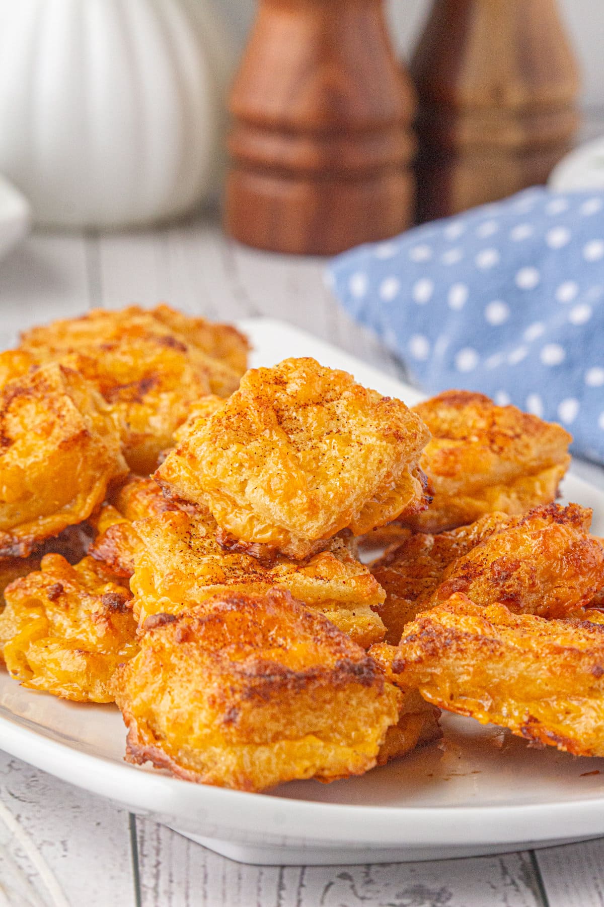 An up-close photo of crisp cheese dreams on a plate.