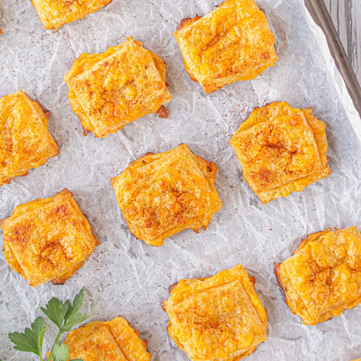 An overhead view of a pan of baked cheese dreams with a golden brown crust.