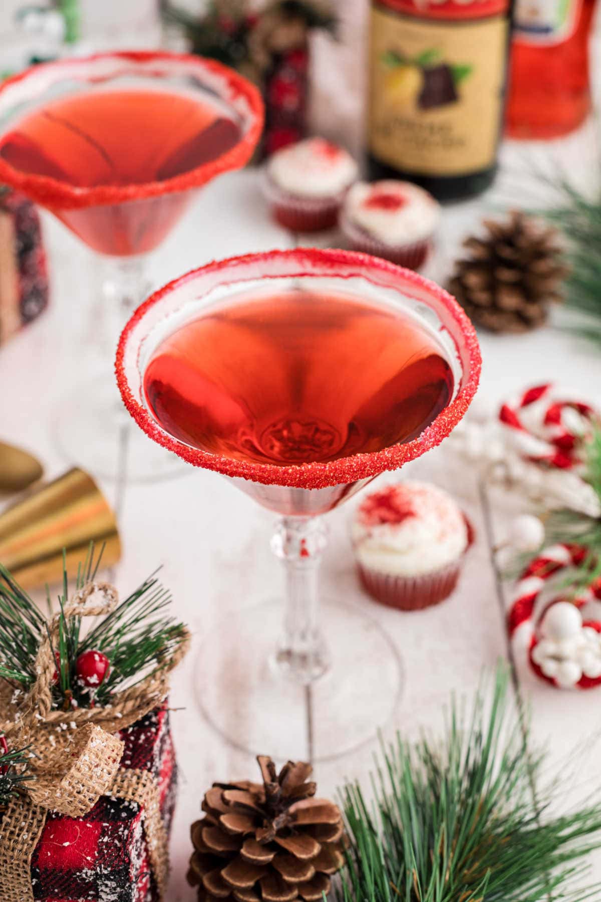 A red velvet martini in a martini glass with a red sugar rim.