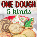 A plate of Christmas cookies on a white table.