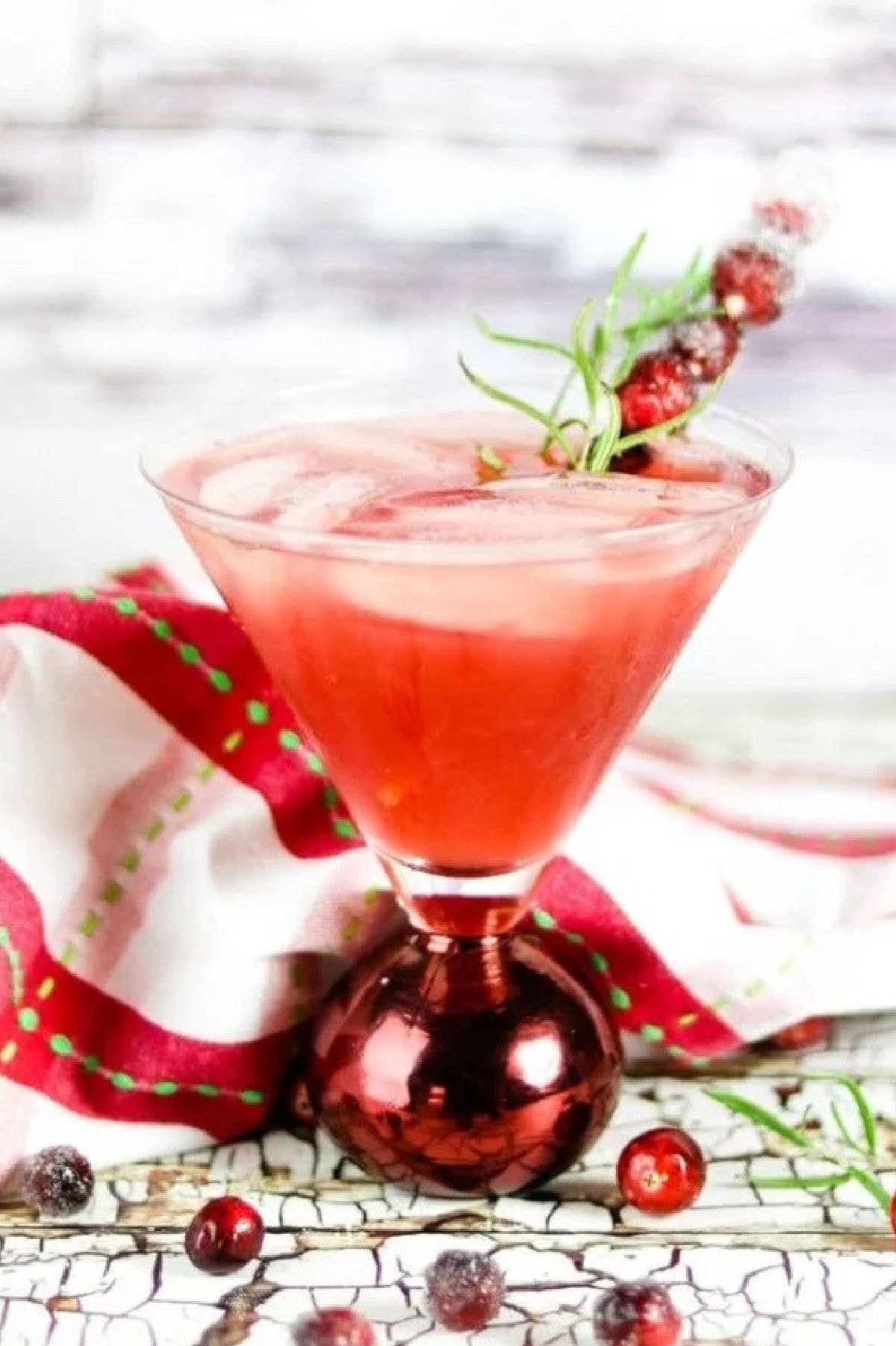 A bright red cocktail in a martini glass.