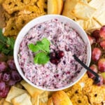 Overhead view of creamy cranberry jalapeno dip on a snack board.