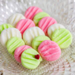 Pink, green, and white mint candied in a candy dish.