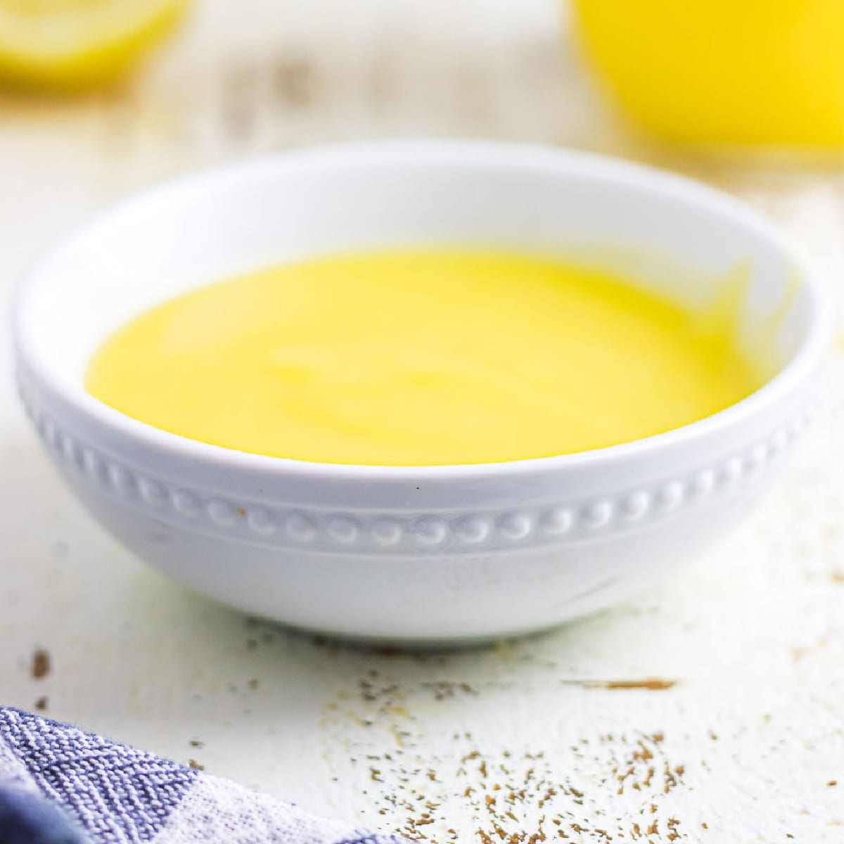 A bowl of lemon curd on a table.