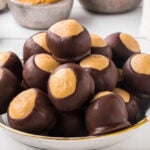 Chocolate peanut butter balls on a plate with a title text overlay for Pinterest.