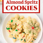 Overhead view of a plate of spritz cookies with a title text overlay for Pinterest.