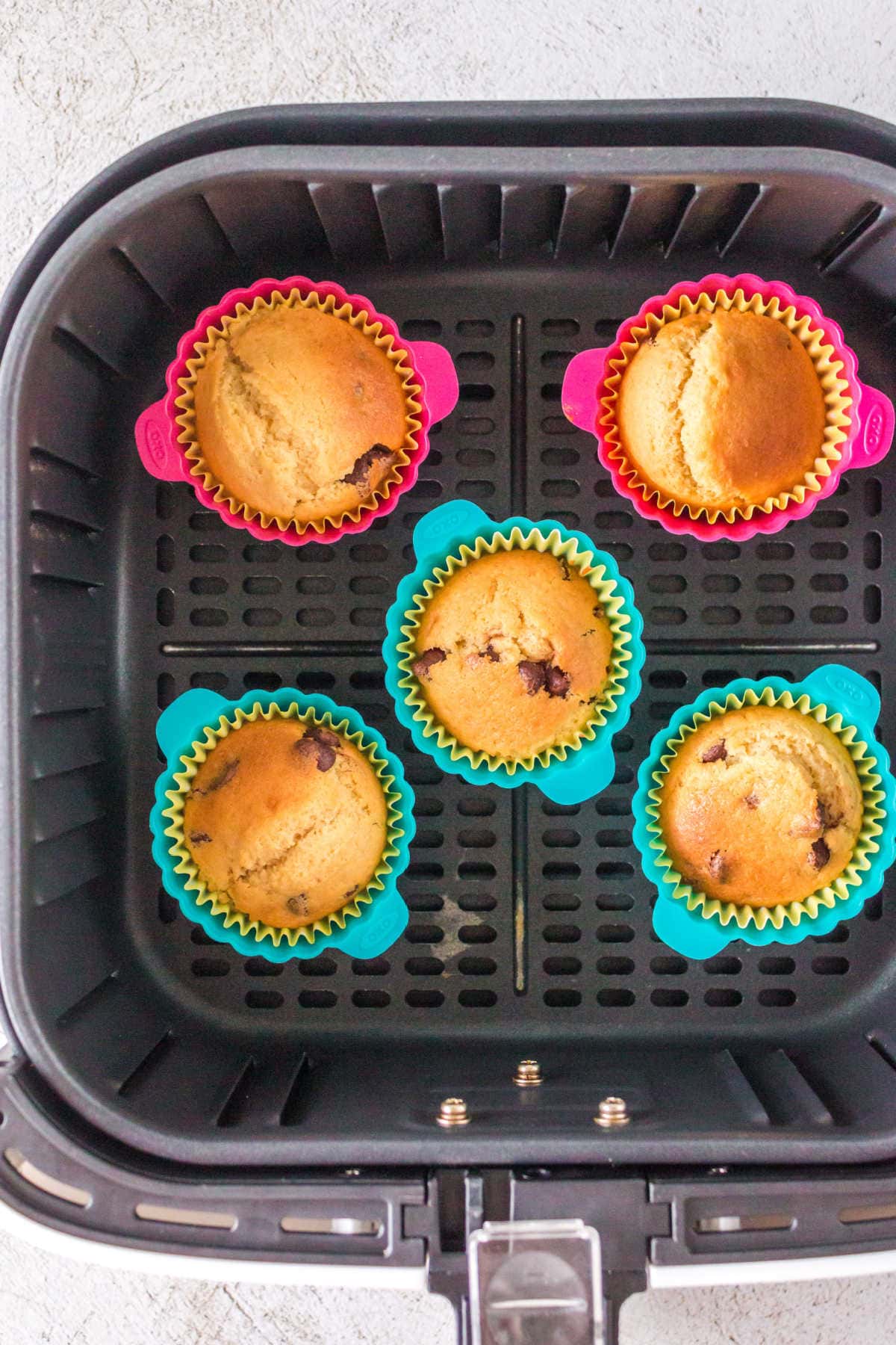 Overhead view of finished chocolate chip muffins in the air fryer.