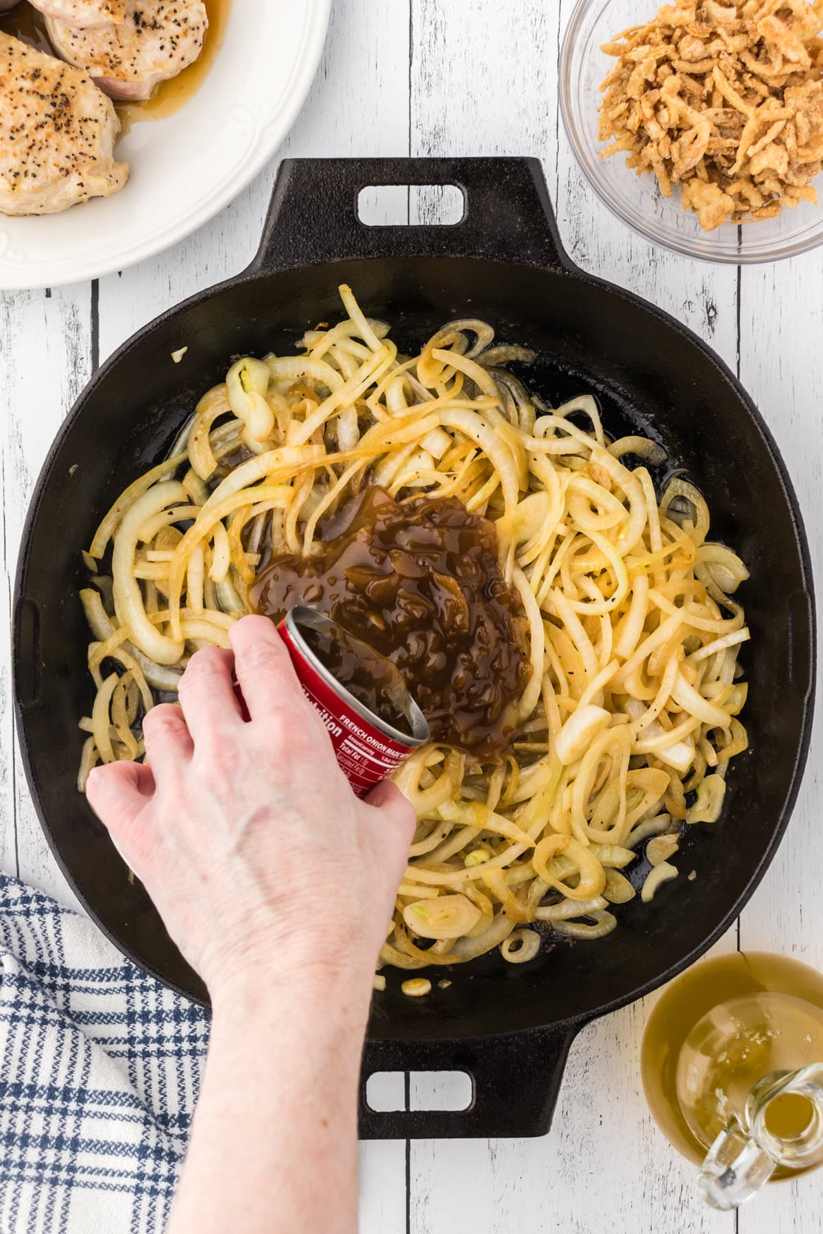 French onion soup being poured over caramelized onions.