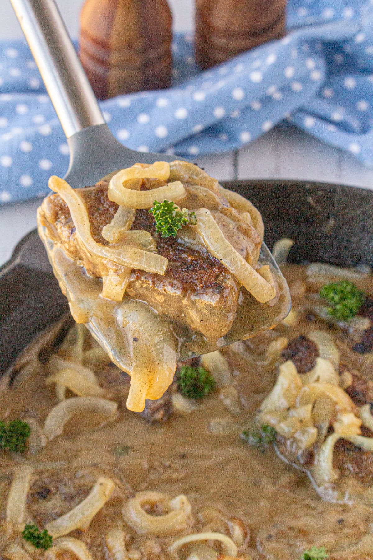 A large spoonful of liver, onions, gravy and some parsley.