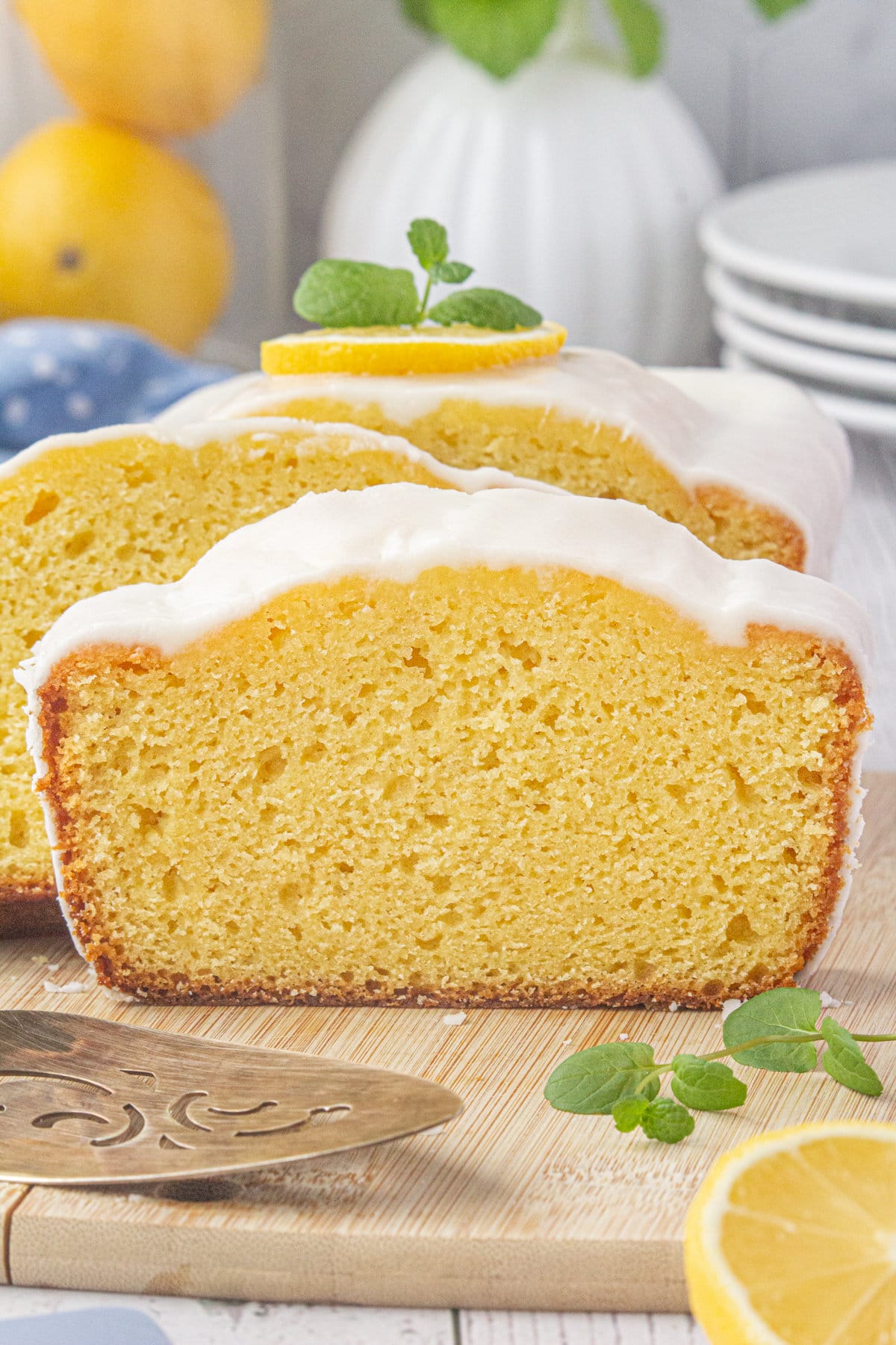 A close-up view of sliced and glazed lemon loaf.