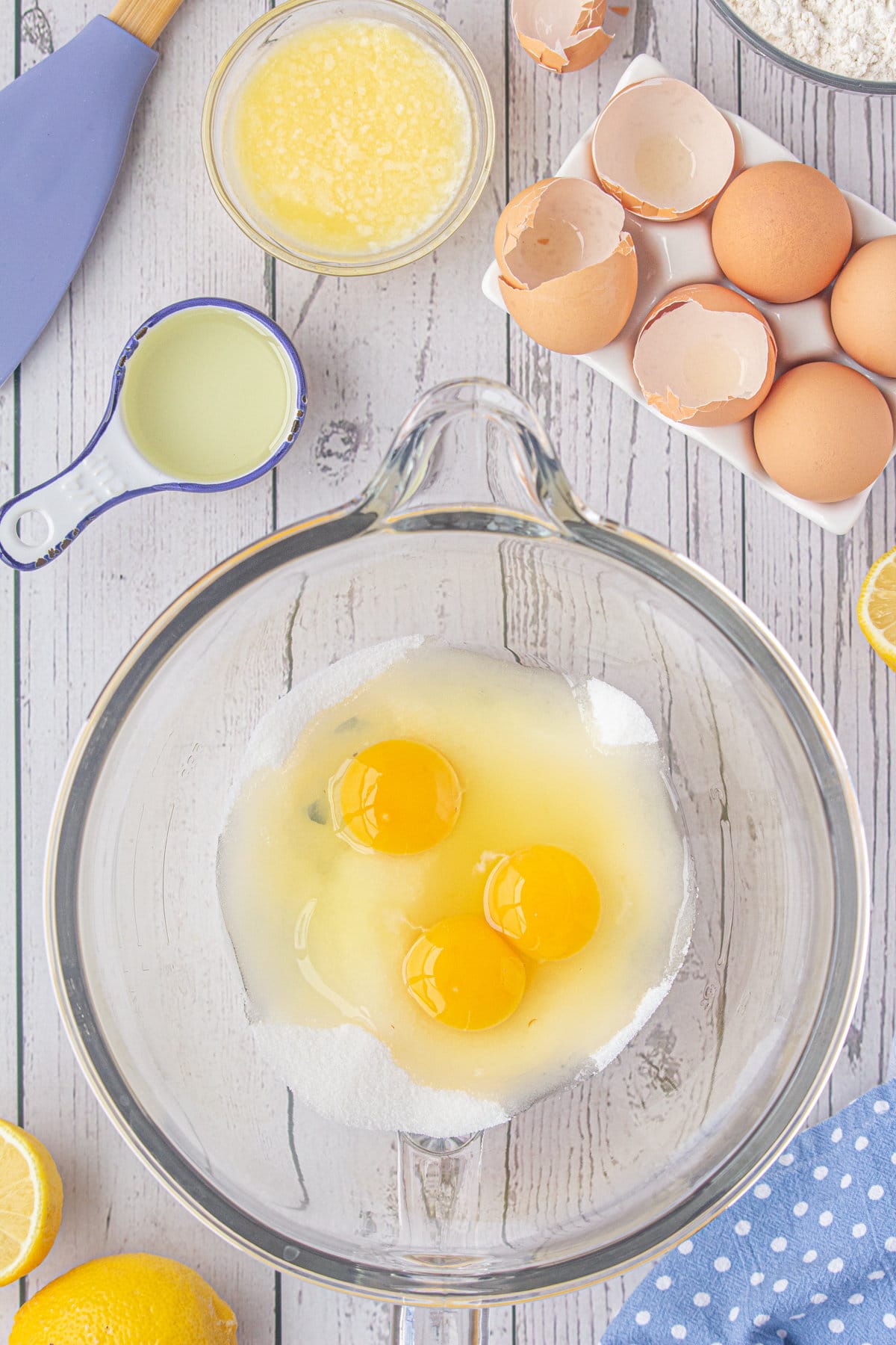 The eggs and sugar in a mixing bowl.