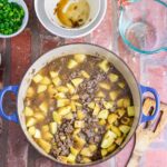Beef and potatoes in a pot.