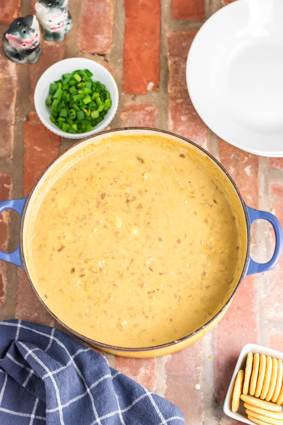 An overhead view of cheeseburger soup in a large pot.