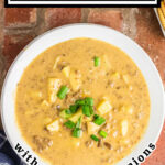 Overhead view of cheeseburger soup with sliced green onions on top. Title text overlay for Pinterest.