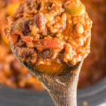 Overhead view of a spoonful of chili with text overlay for Pinterest.