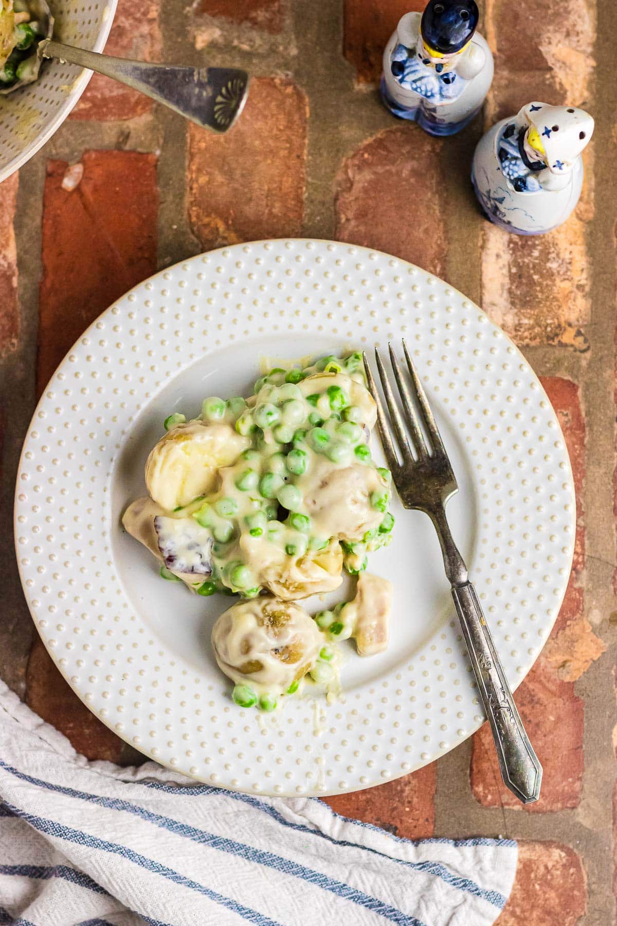 A plate of creamed potatoes and peas.