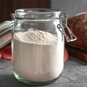 An open jar with dough enhancer in it for the featured image.