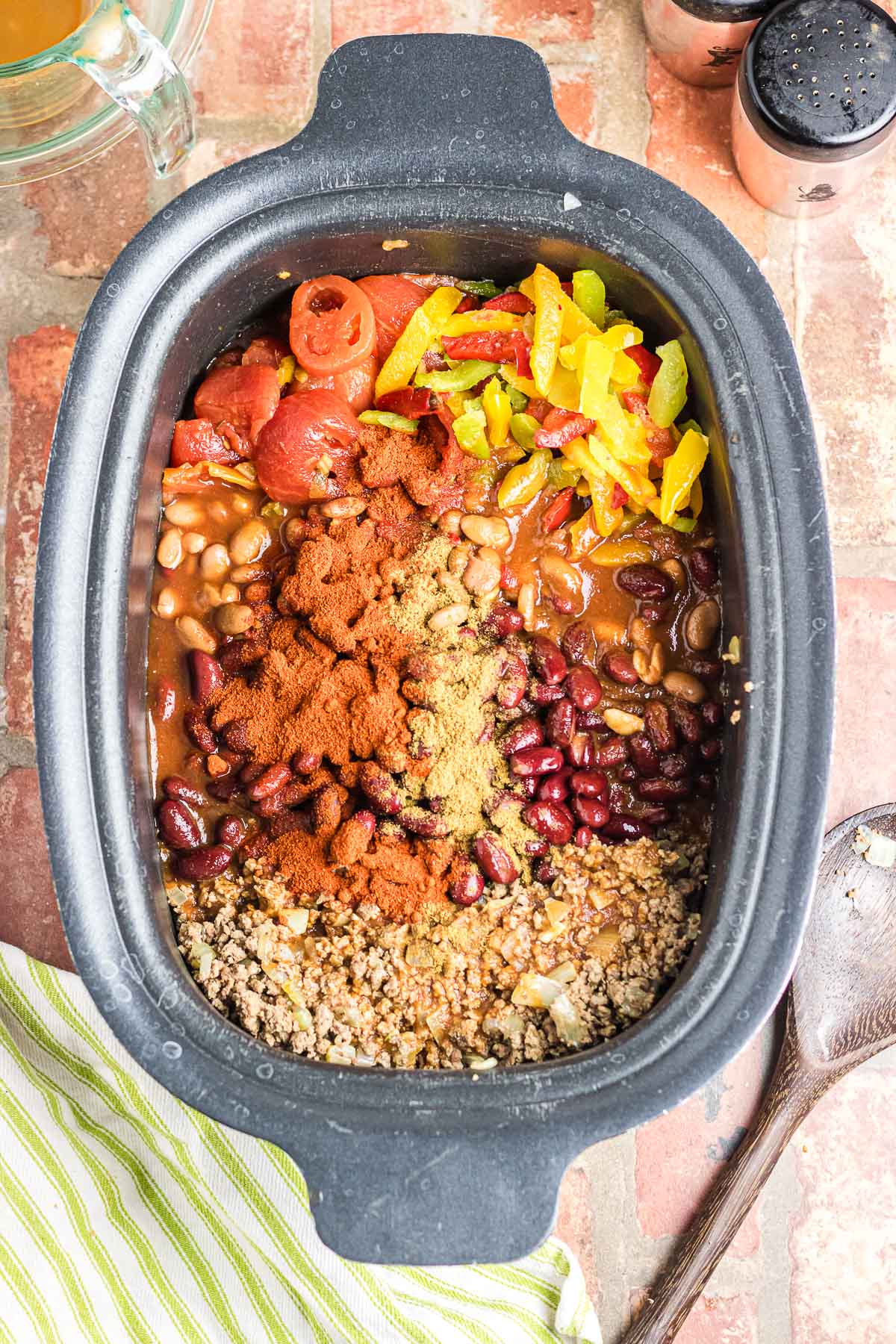 An overhead photo of a crockpot filled with chili ingredients.