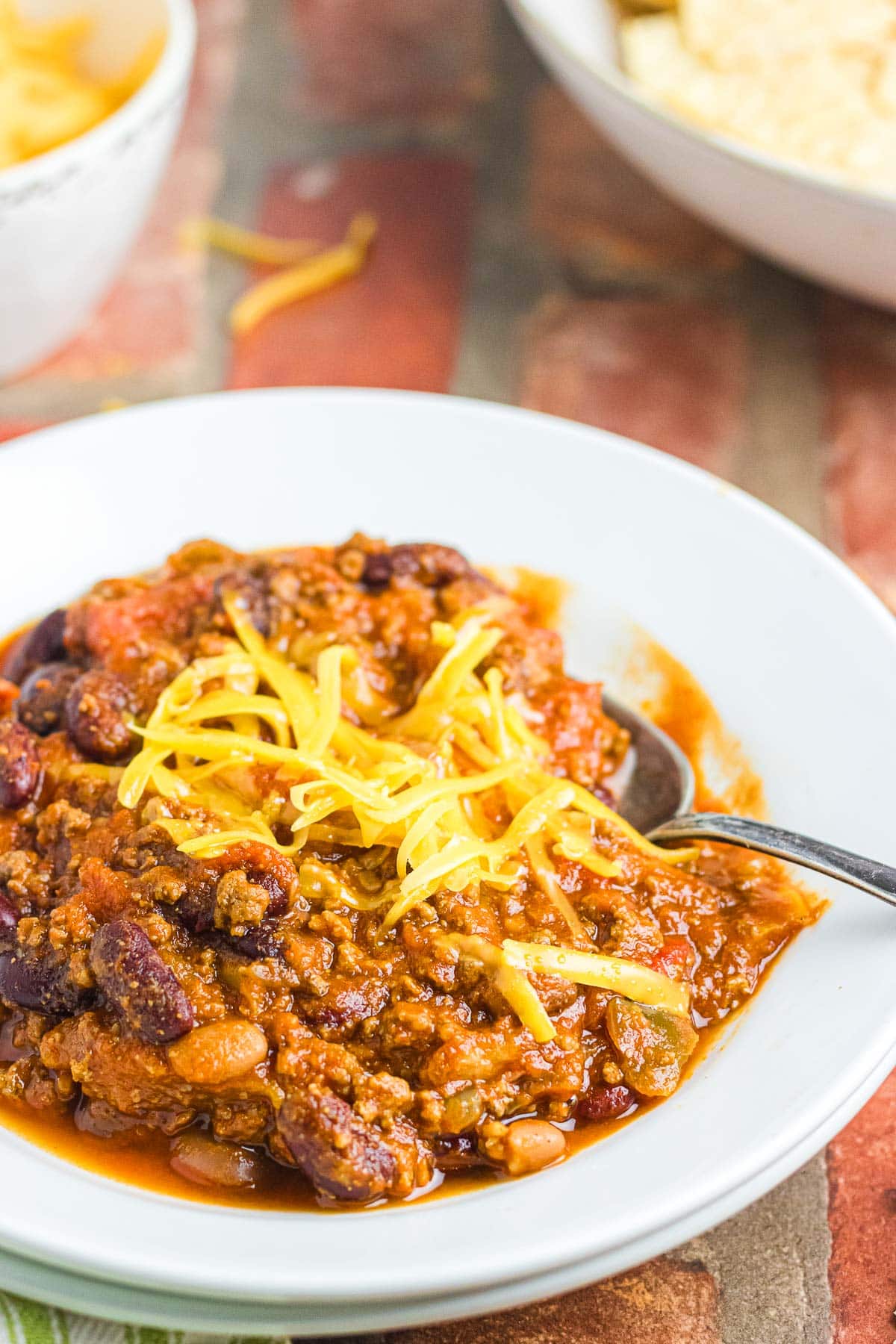 An up-close photo of a bowl of Wendy's chili topped with cheese.