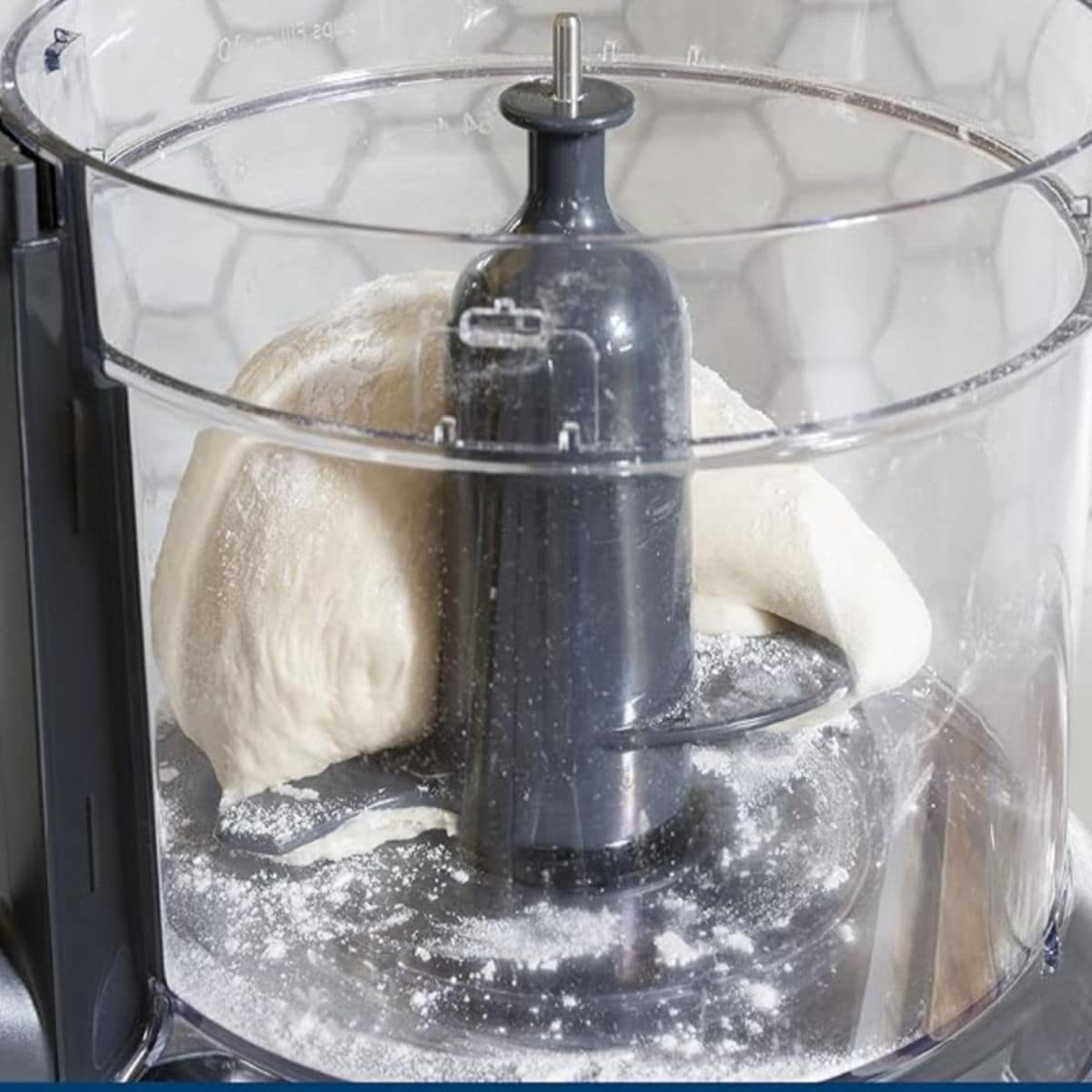 Food processor with dough inside.