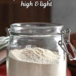 An open jar of dough enhancer sitting on a tabletop.