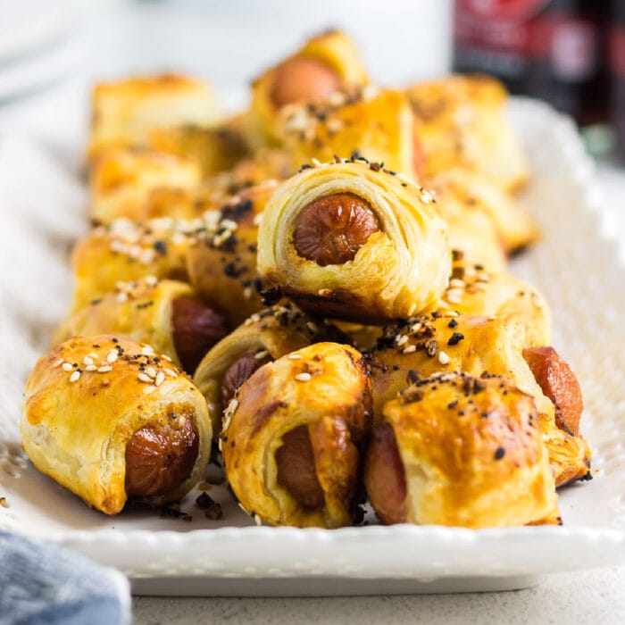 Close up of hot dogs wrapped in golden brown puff pastry.