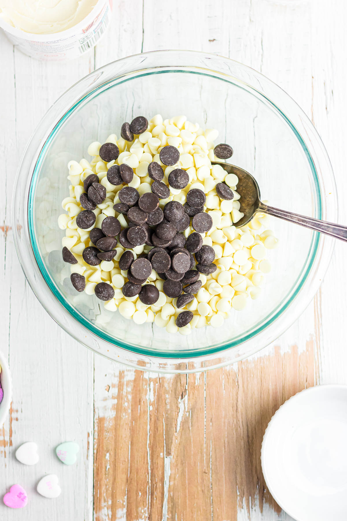 White and regular chocolate chips in a bowl.