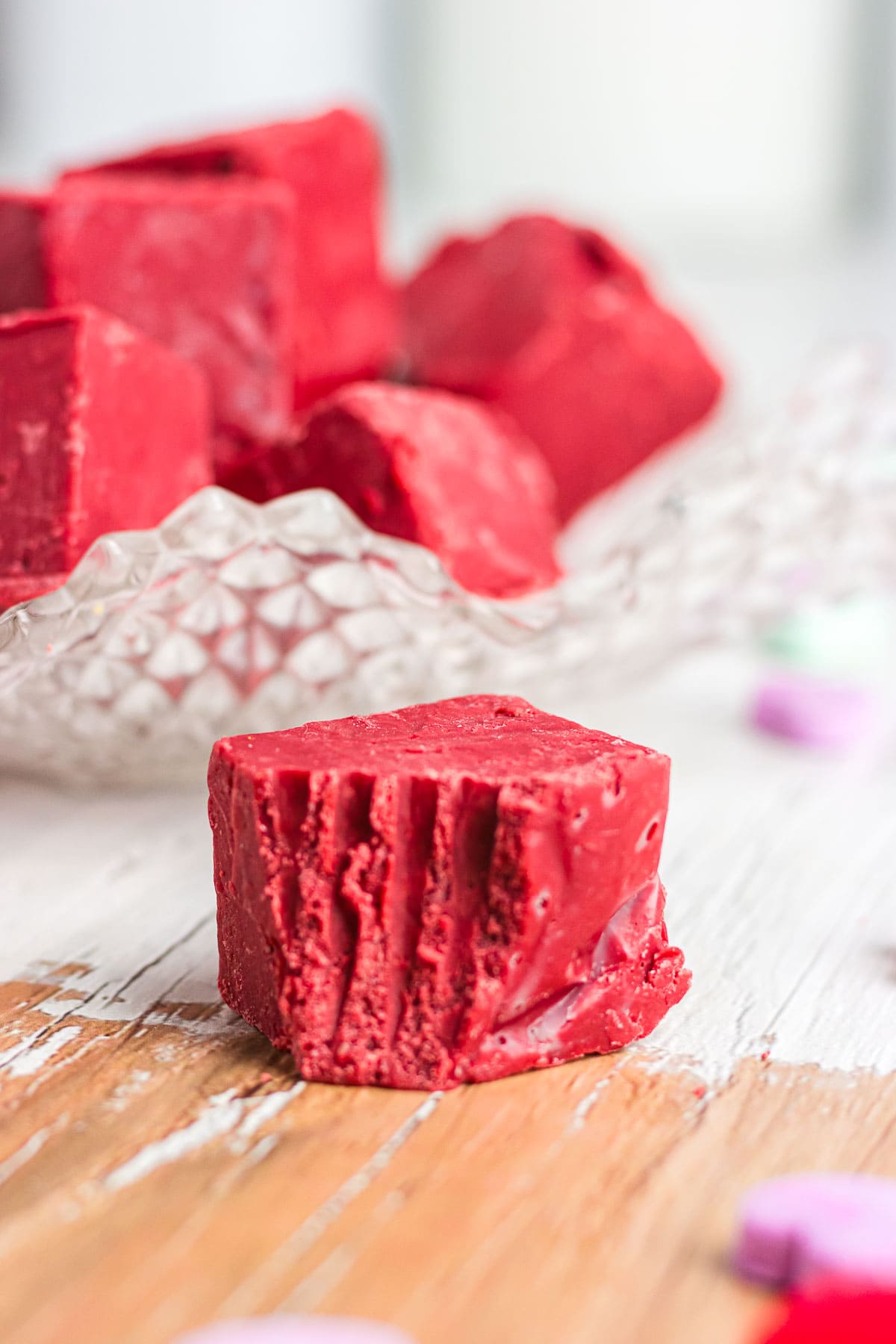 An up-close photo of red velvet fudge with a bite taken out of it.