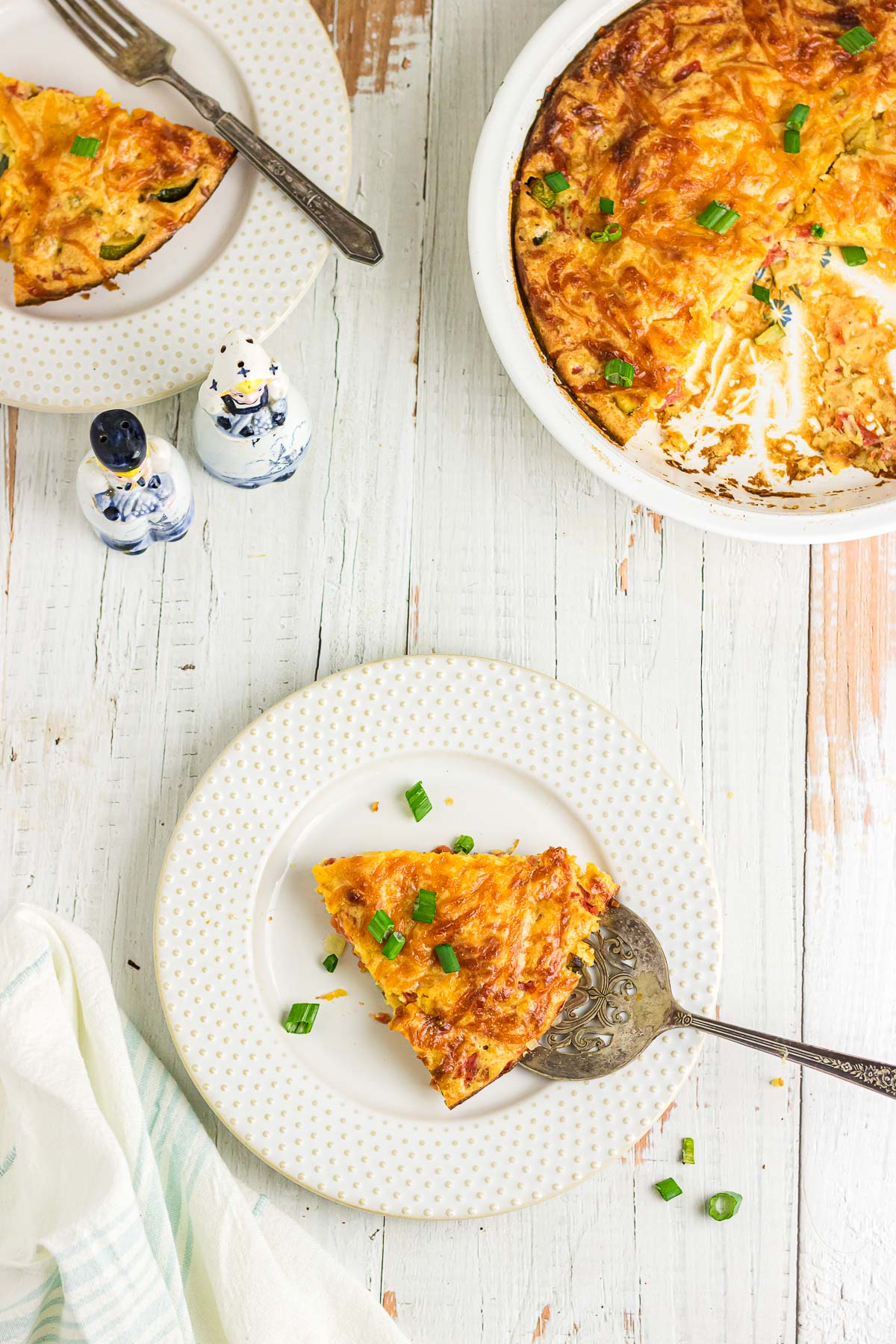 A plate and pie server with a slice of impossible zucchini pie.