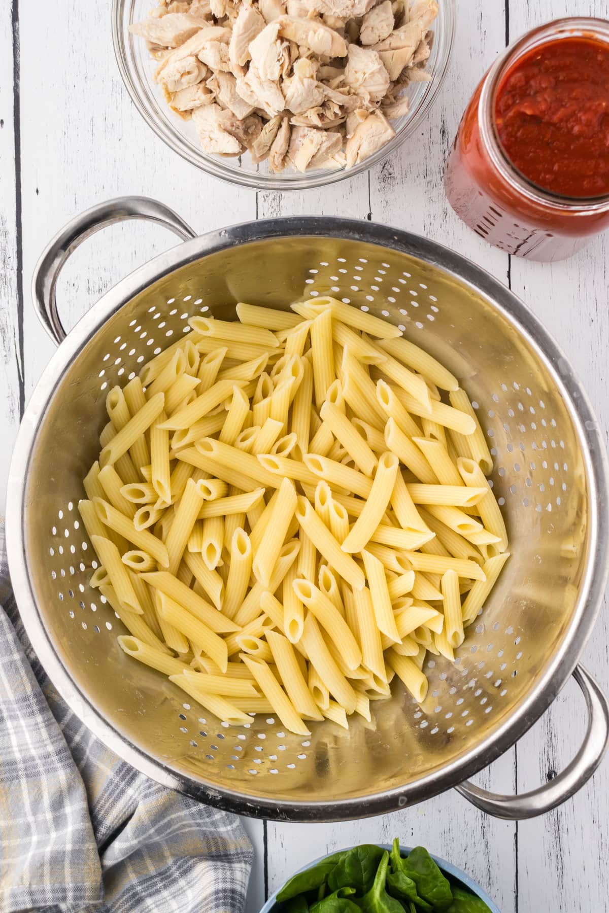 Cooked pasta in a pasta strainer.