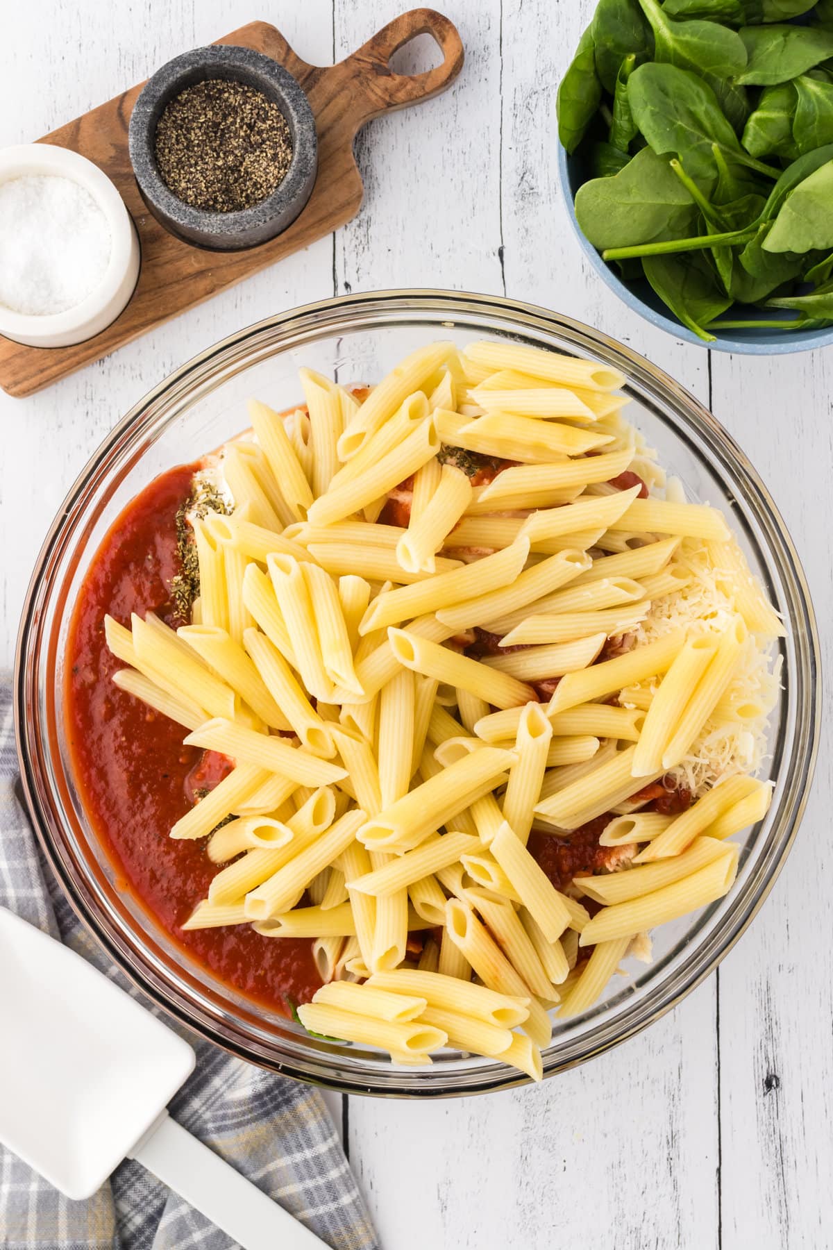 Adding the pasta to the sauce mixture.