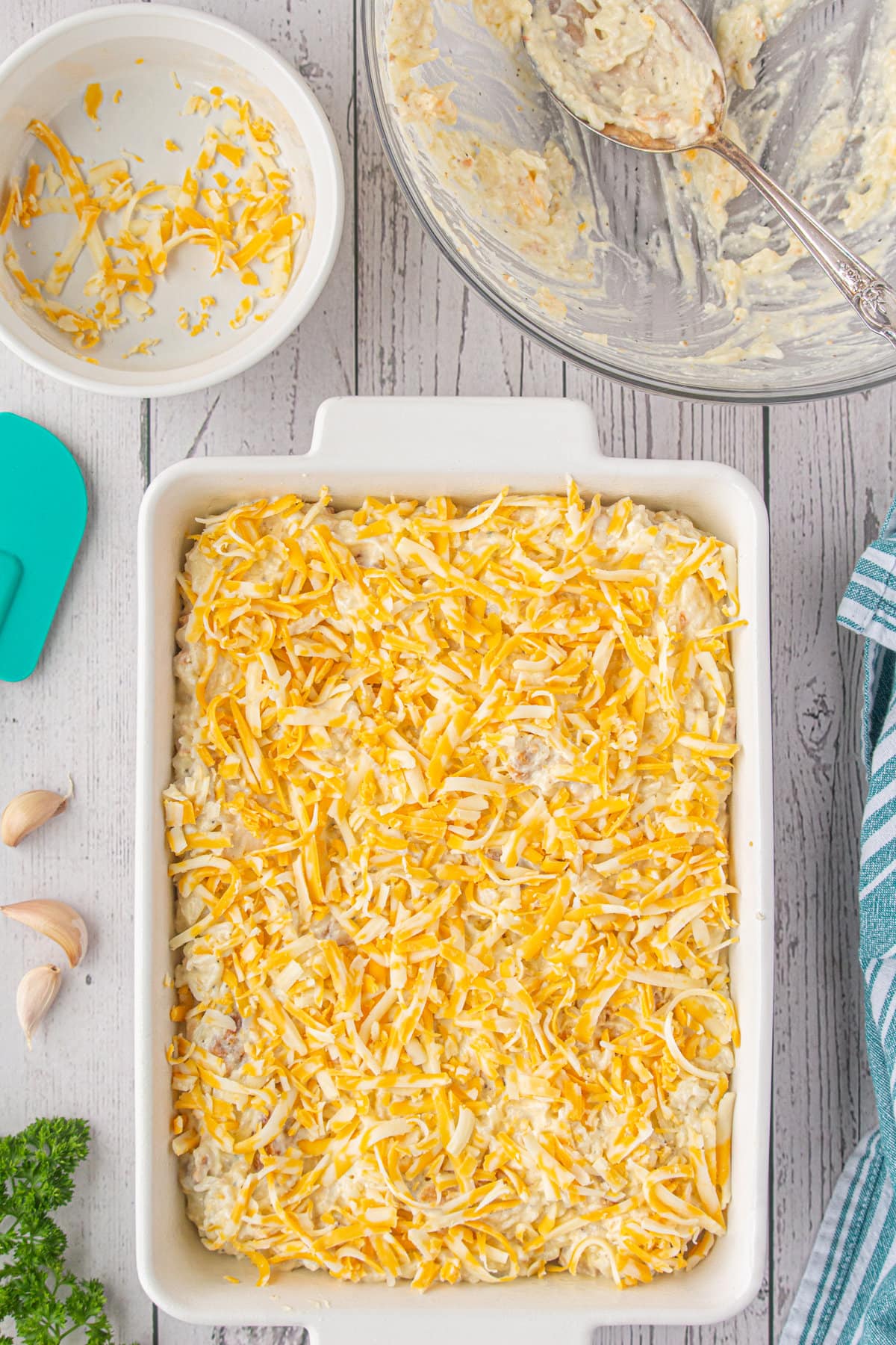 The unbaked casserole topped with more cheese.