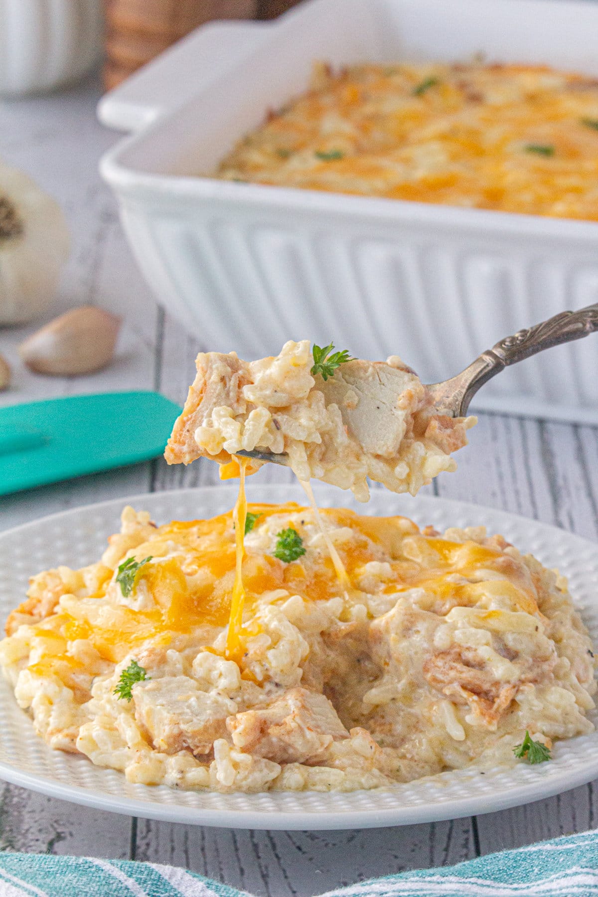 Angel chicken and rice casserole on a plate with some scooped on a fork.