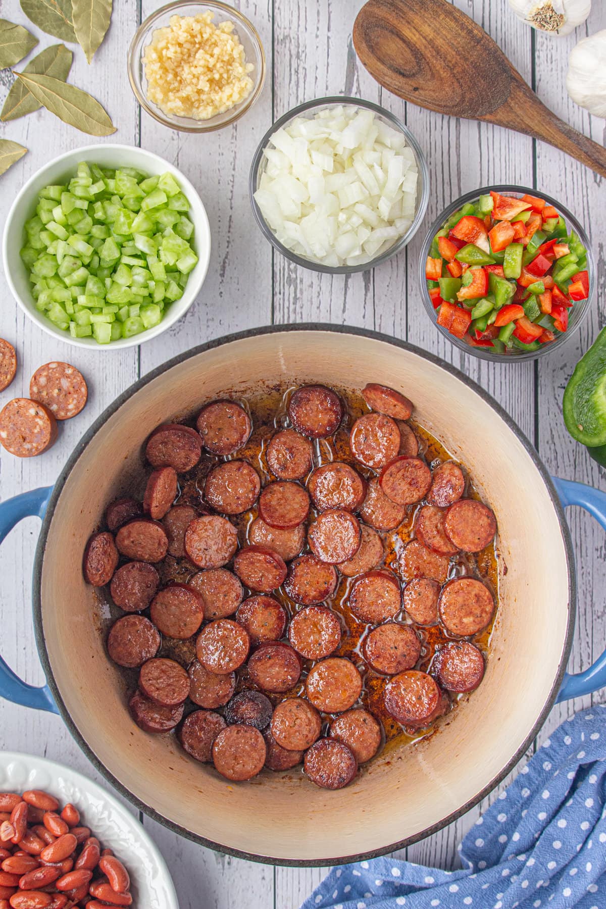 Searing the sausage slices in a Dutch oven.