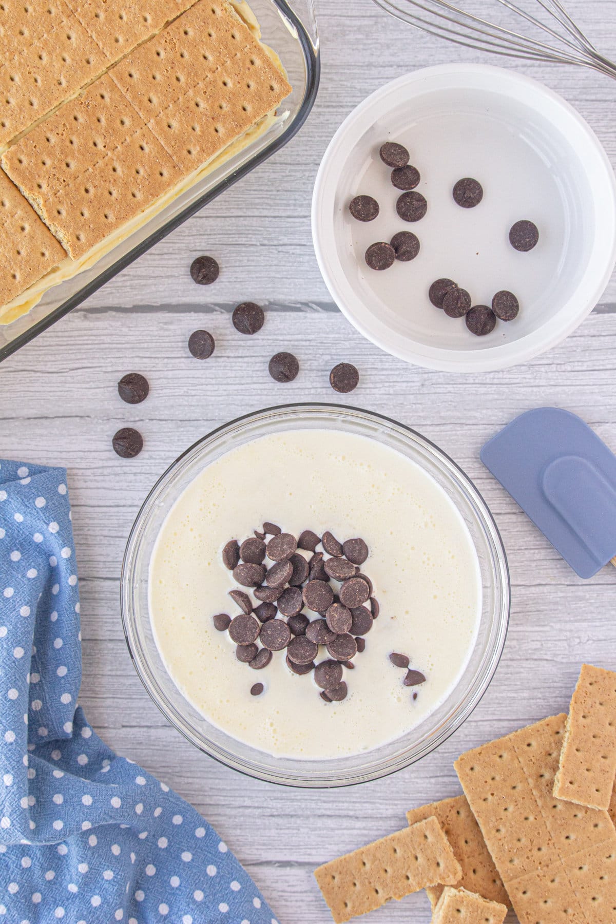 A bowl with heavy cream and chocolate chips.