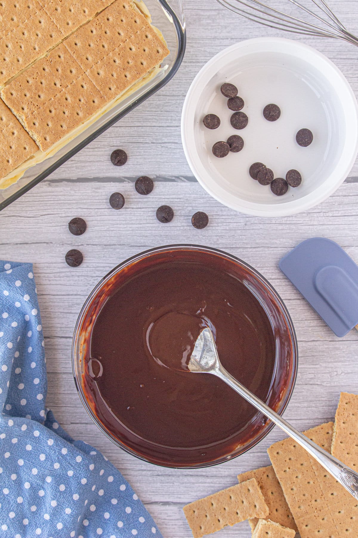A bowl with chocolate ganache and a spoon.