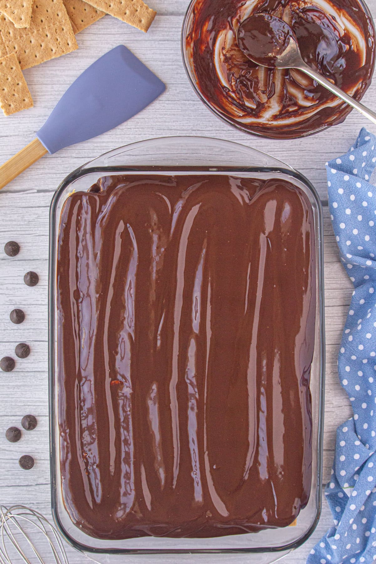 Ganache spread over top of the eclair cake.