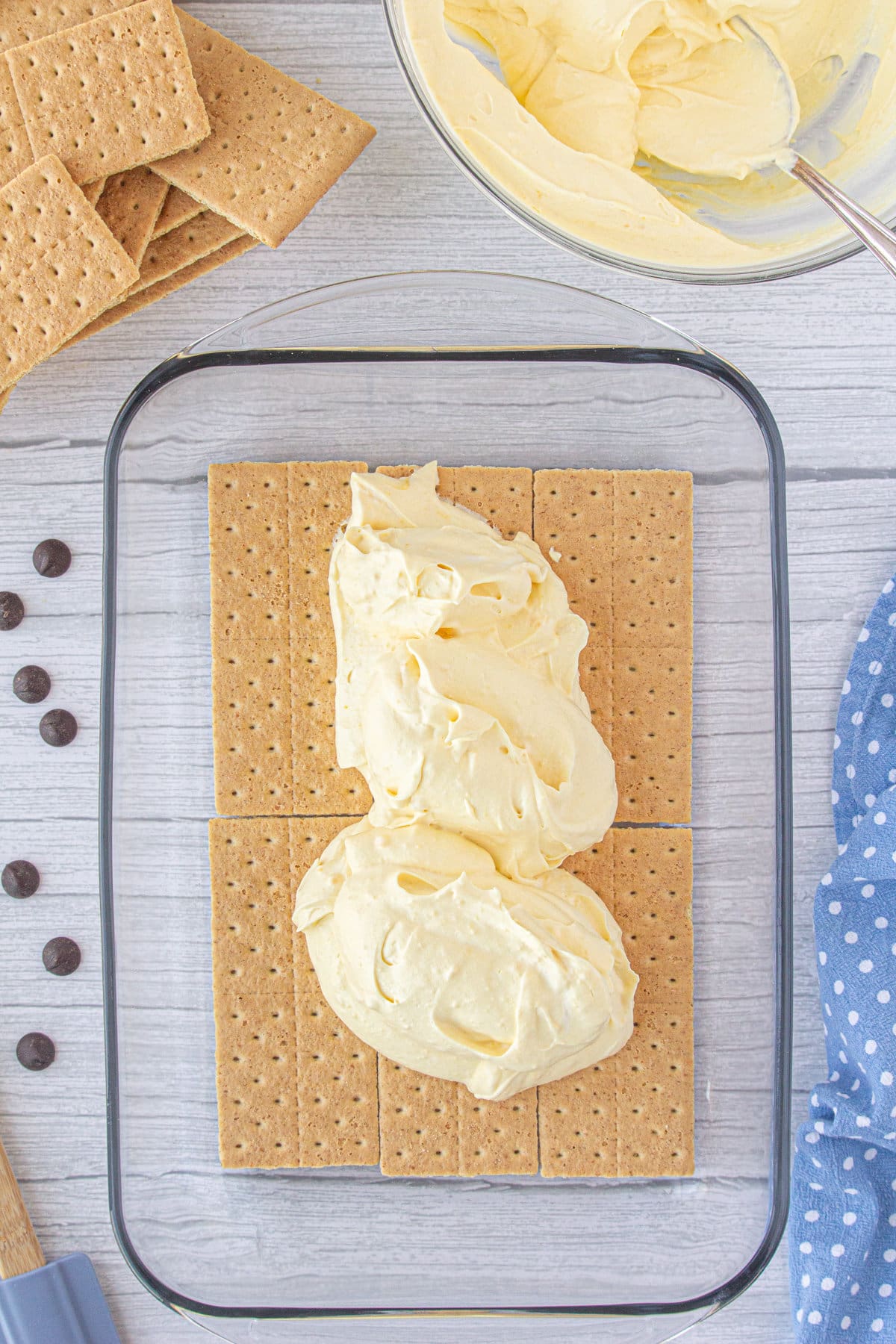 Graham crackers in a baking dish topped with pudding mixture.