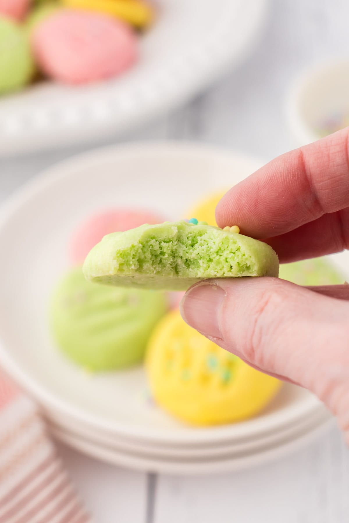 An up-close photo of a mint meltaway cookie with a bite taken out.