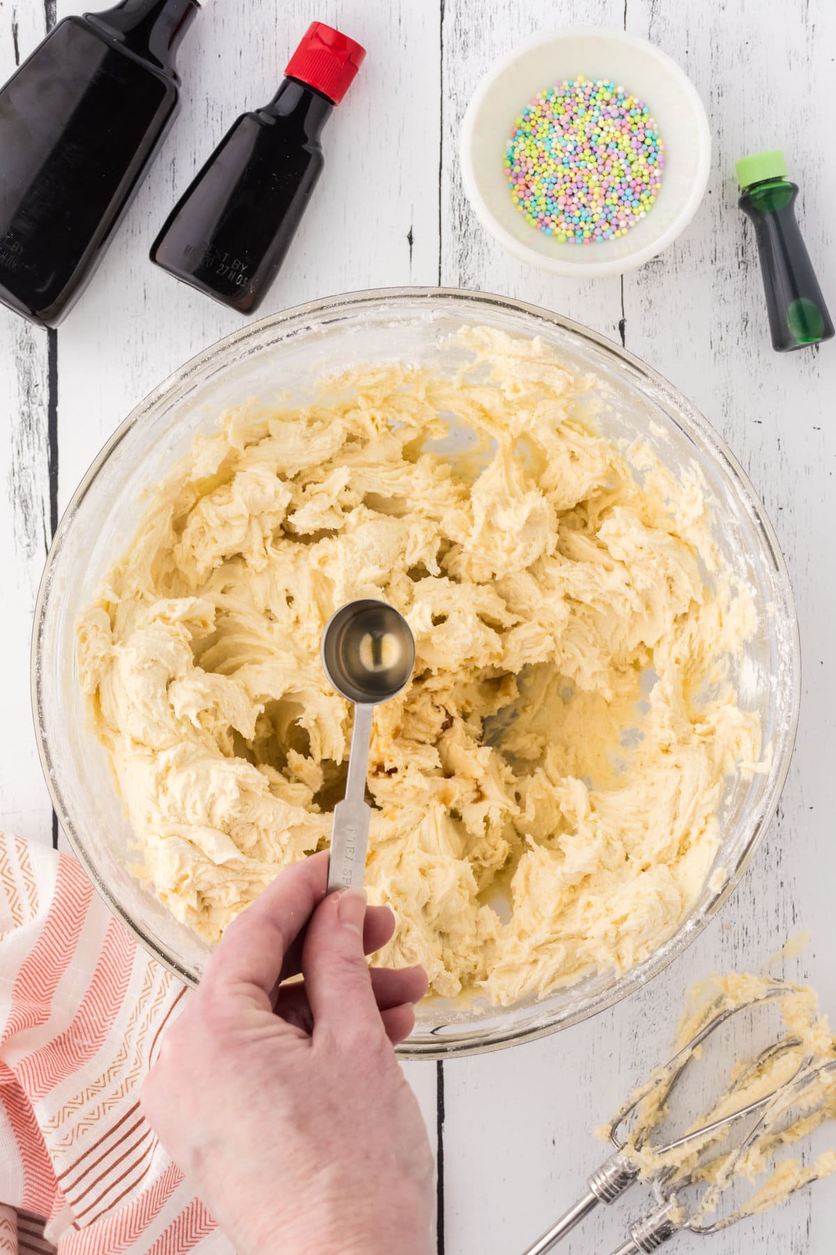 Adding extract to the dough.