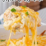 Creamy chicken and rice on a serving spoon with a title text overlay for Pinterest.